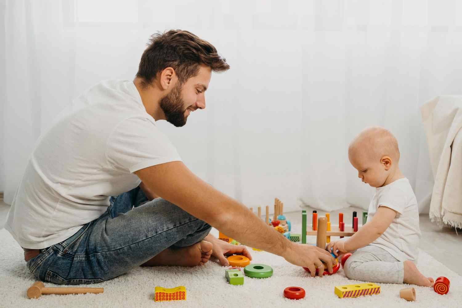 A father and his baby playing with toys on the floor